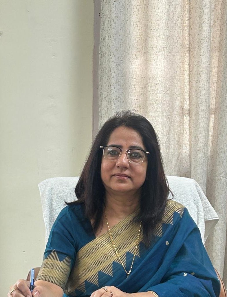 Portrait of college principal standing in official attire with college logo in background